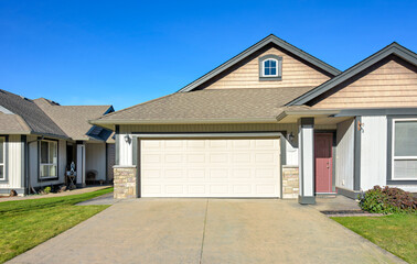 Wide garage of a nice residential house on bright winter day in British Columbia, Canada