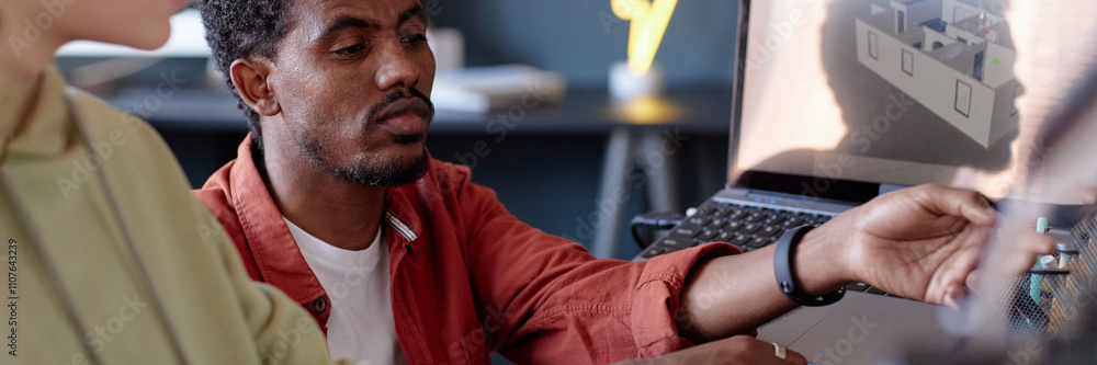 Poster portrait of an african american man working with a colleague on an architectural design displayed on