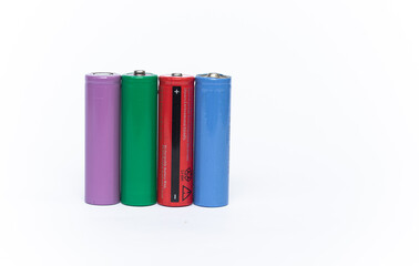4 colorful cylindrical batteries on a white background. Storage battery or secondary cell....