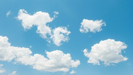 Fototapeta premium Fluffy white clouds drifting against a bright blue sky, tranquil