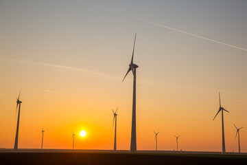 Obraz premium Sunrise Over Countryside Wind Turbines Generating Renewable Electricity