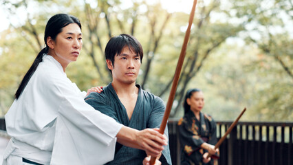 Martial arts, man and master with wood sword with fight, battle and samurai training class. Park,...