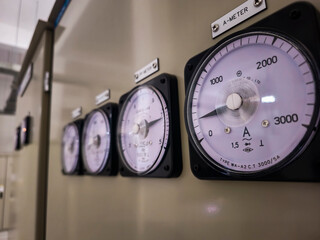 Four meters are on the electric panel, each with a different number