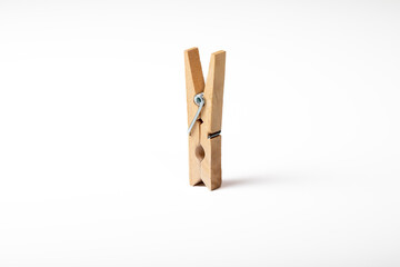Wooden clothes peg isolated on white background
