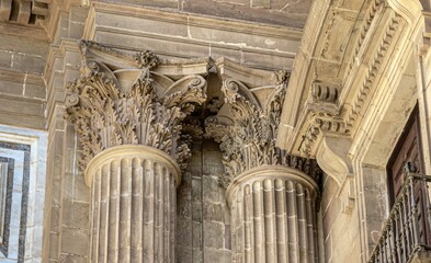 Detail of the sculpted heads of the columns of the Cathedral of the Incarnation, Malaga, Spain