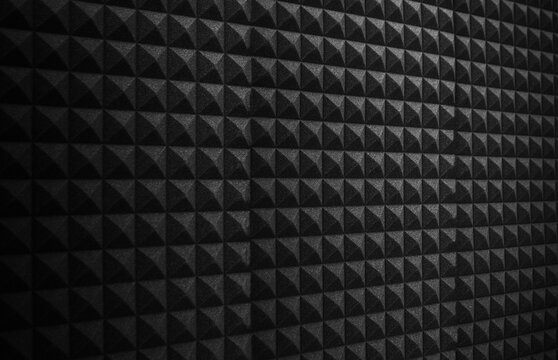 wide dark black acoustic foam wall in recording studio. Sound proofing for music recording, podcast production or radio station