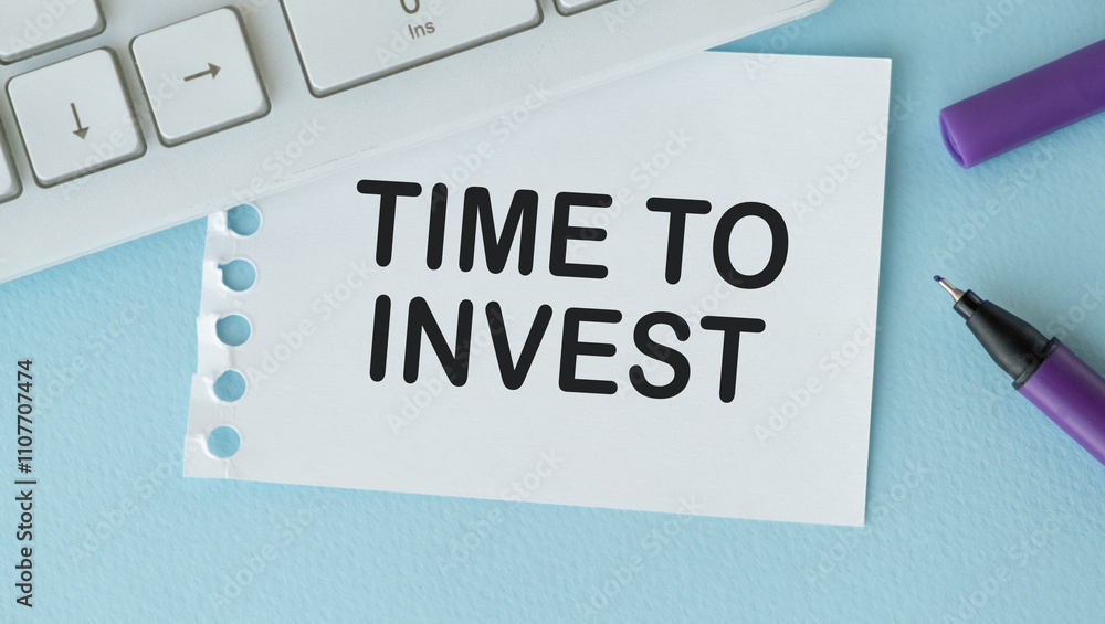 Poster time to invest text on a notebook with keyboard on blue background