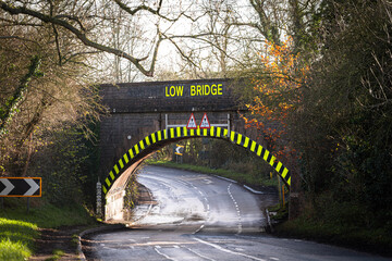 Low bridge sign indicating height restriction on a country road