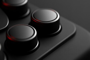 Close-up of Sleek Black Control Knobs on Modern Electronic Device for Precision Adjustment