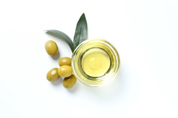 Bowl of fresh olive oil and olives with leaves on white background