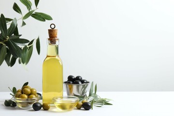 Bottle of fresh olive oil and olives on table