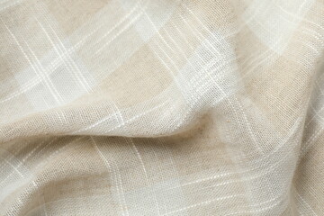 Beige fabric checkered background, close up view