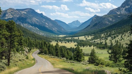 Scenic winding road through a lush valley surrounded by mountains under a blue sky.