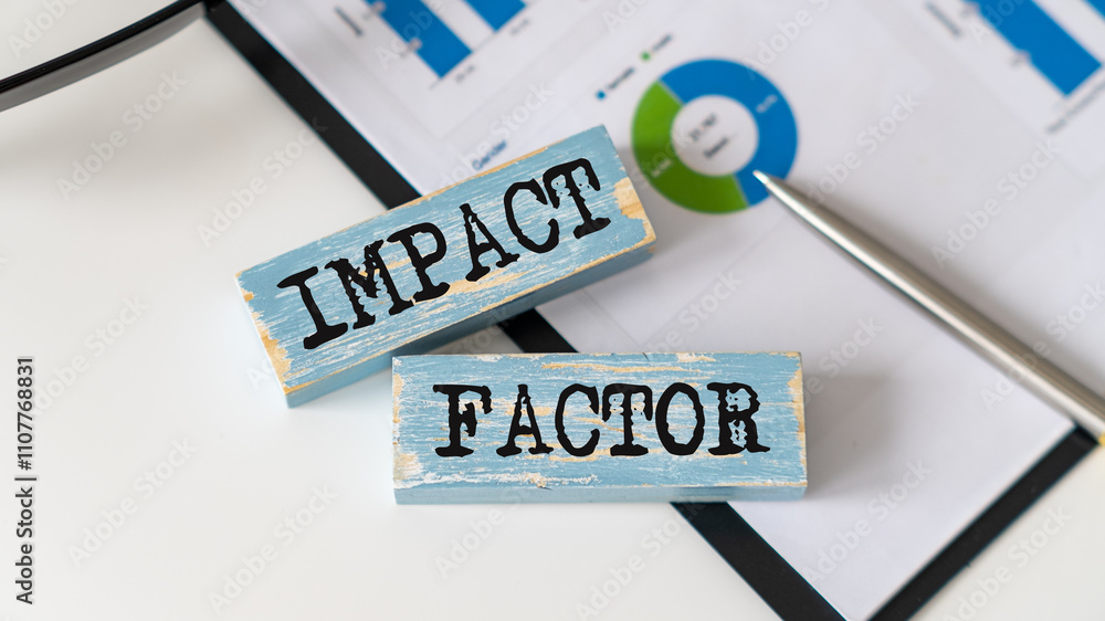 Poster closeup on notebook and desk background, front focus on wooden blocks with letters making impact fac