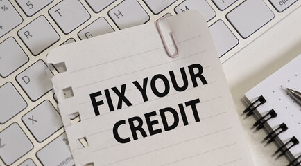 Writing note shows the text Fix your credit, business credit.