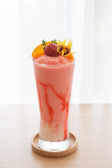 Strawberry smoothie on a wooden table  