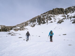 Two Snowshoers Climbing Snowy Slope Near Mont Chaberton