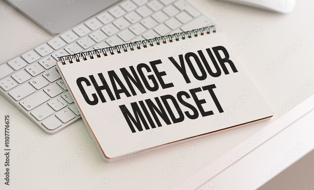 Poster change your mindset. wooden table. torn page from a notebook on two notebooks with text