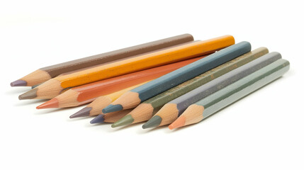 Fototapeta premium Close-up of eight colored pencils in earthy tones, arranged in a fanned pattern on a white background.