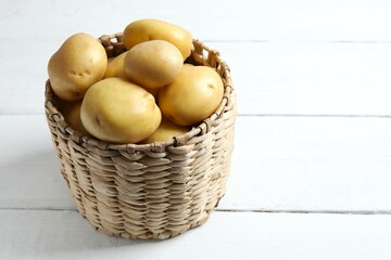 Young potatoes. Fresh potatoes on a wooden background. Harvesting collection. organic, freshly dug...