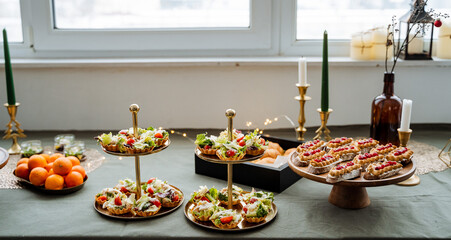 On a beautifully set table, there is a delightful spread of plates filled with various types of...