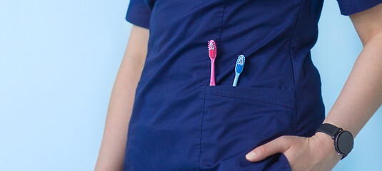 two toothbrushes in the nurse's pocket. banner for the clinic