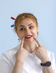 A pretty girl shows a smile with white healthy teeth. There are two toothbrushes in the hair. Medicine. Dentistry