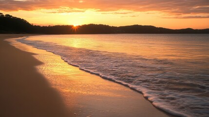 Fototapeta premium gentle ocean waves rolling onto a sandy beach at sunset