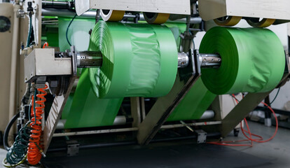 Closeup roll on extruder of polyethylene for process production of plastic bags