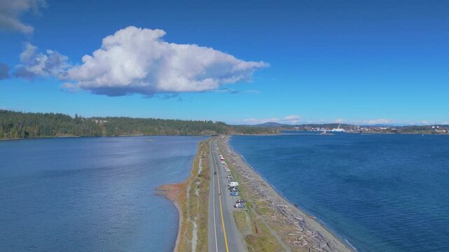Aerial view of Coburg Peninsula with calm blue waters and lush greenery under a clear sky in Victoria British Columbia Canada