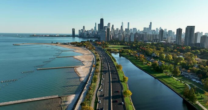 Aerial above the road leading to Chicago Downtown with skyscrapers on horizon. Sunny day, fall season