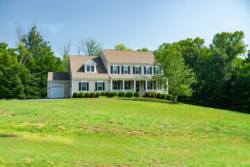 Obraz premium Beautiful modern exterior of a farmhouse style country house with a large lawn
