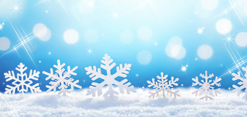 Snowflakes in snow on blue background, with copy space, banner, Christmas background