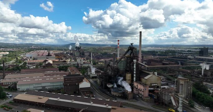 Drone view of blast furnace 'metal production site' with smokestacks in Saar Dillingen, Germany