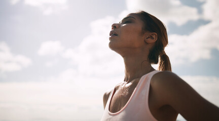 Outdoor, woman and running break with sweat or breathe for fitness, health and self care. Female...
