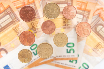Euro cents close up and euro banknotes in blur. Business concept