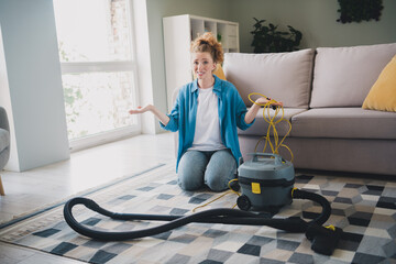 Full size photo of young ginger woman stressed repair vacuum cleaner confused dressed blue outfit...