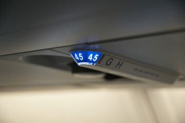 Above the Clouds, November 24, 2018: Seat Row Display and No Smoking Sign on the Ceiling of a Long-Haul Airplane