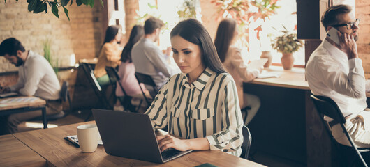 Focused leader girl ceo manager sit desk work laptop typing chatting watch start up development aim...