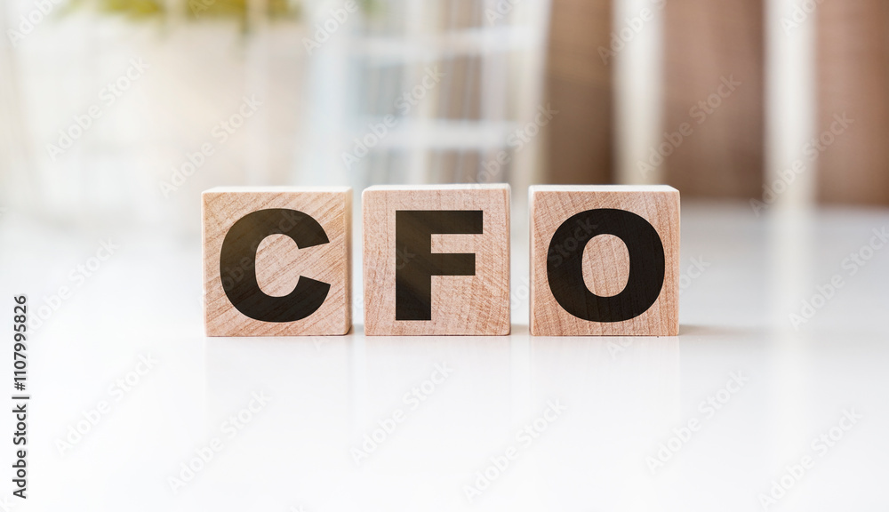 Aufkleber text cfo on a wooden cube blocks on notepad background