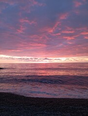 sunset on the beach. Red sunset on the sea. The sun is setting over the sea horizon
