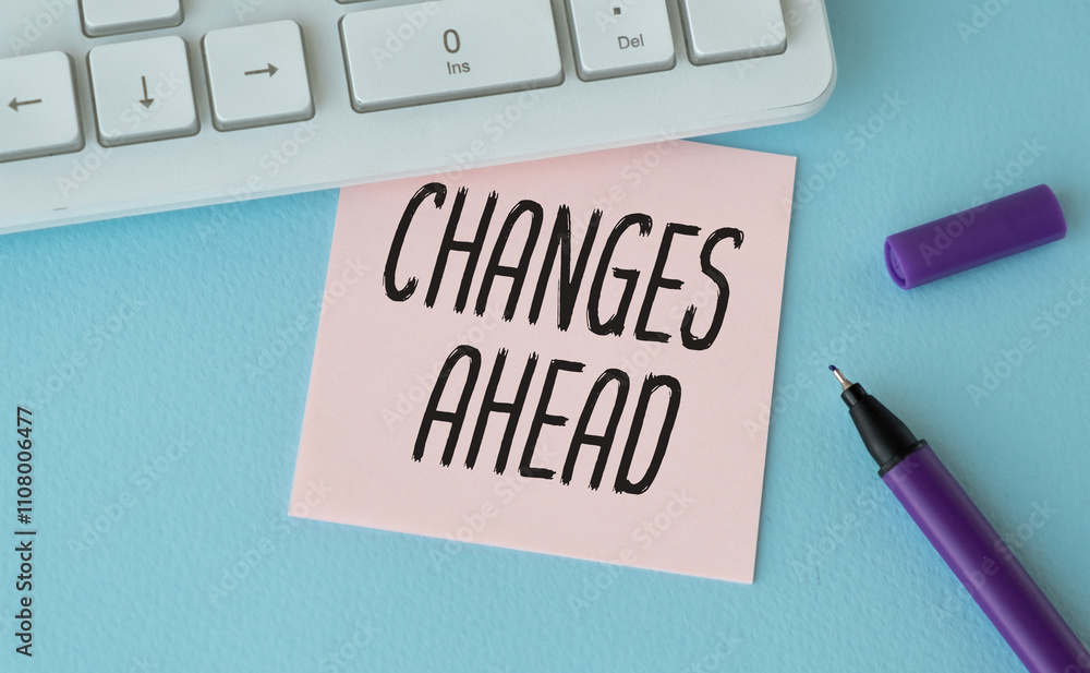 Aufkleber changes ahead text written on sticky on chart with keyboard and pen