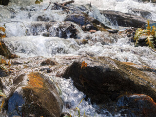 A mountain river with a rapid flow: a mesmerizing stream of water, framed by picturesque mountain...