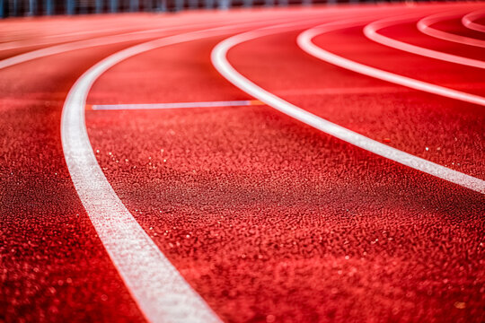 A red running track at a stadium.