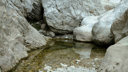 Naklejka premium Lumps of rocks in water with reflection, Gorrori canyon