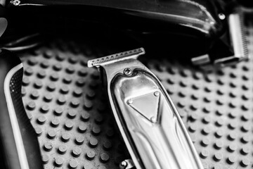 Quality hair clippers arranged on a textured surface in a barbershop setting