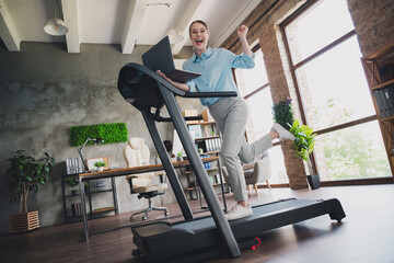 Photo of lucky charming lady assistant wear shirt running treadmill winning game modern device...