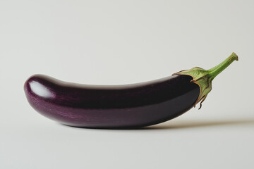 A purple eggplant is shown in its entirety, with the stem