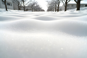 Fototapeta premium Close-up of snow with ripples and shadows on its surface, capturing the intricate textures and patterns formed by wind and light, creating a serene and detailed winter landscape
