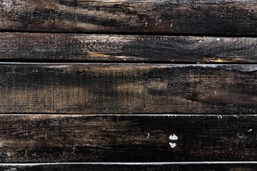 Dark weathered wooden planks create rustic background in minimalist style